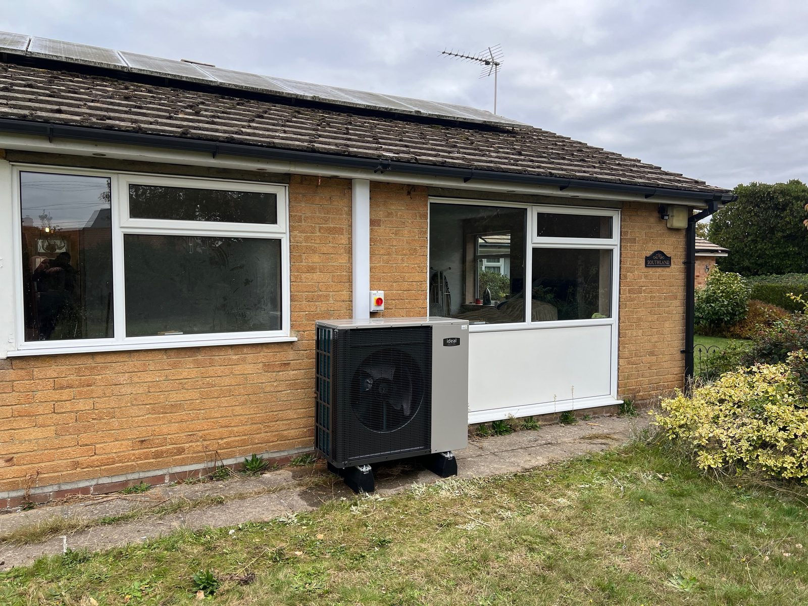 An air source heat pump installed at the side of a Suffolk bungalow