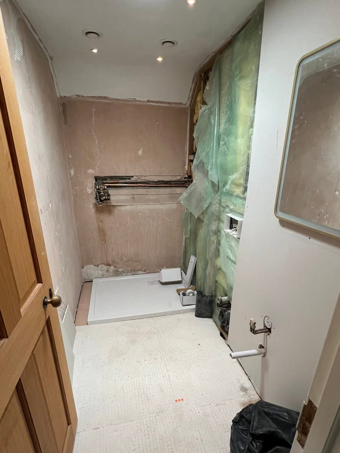 A bathroom at first fix stage, pipework in and walls prepared