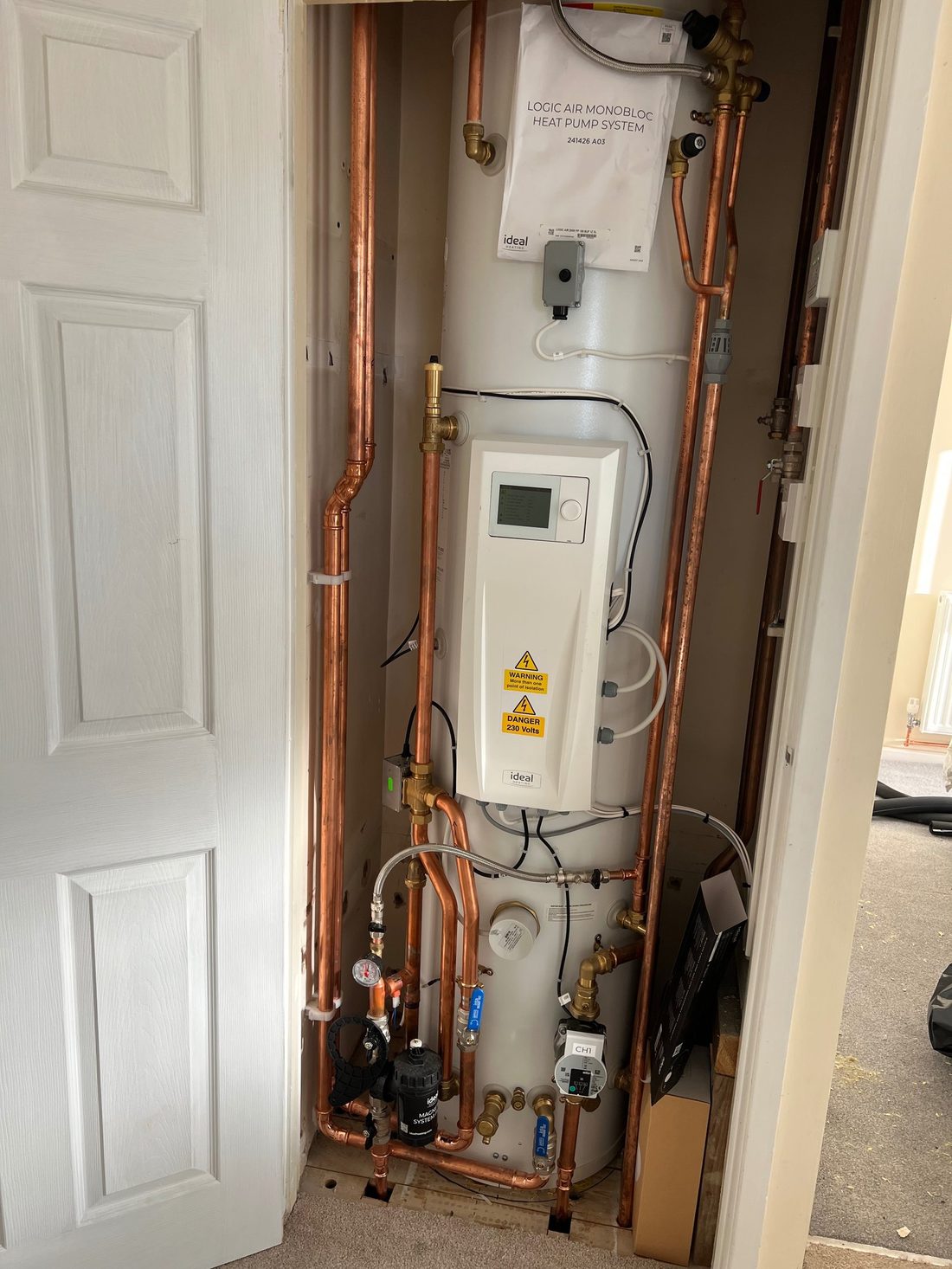 A relocated cylinder and renewed copper pipework in an airing cupboard