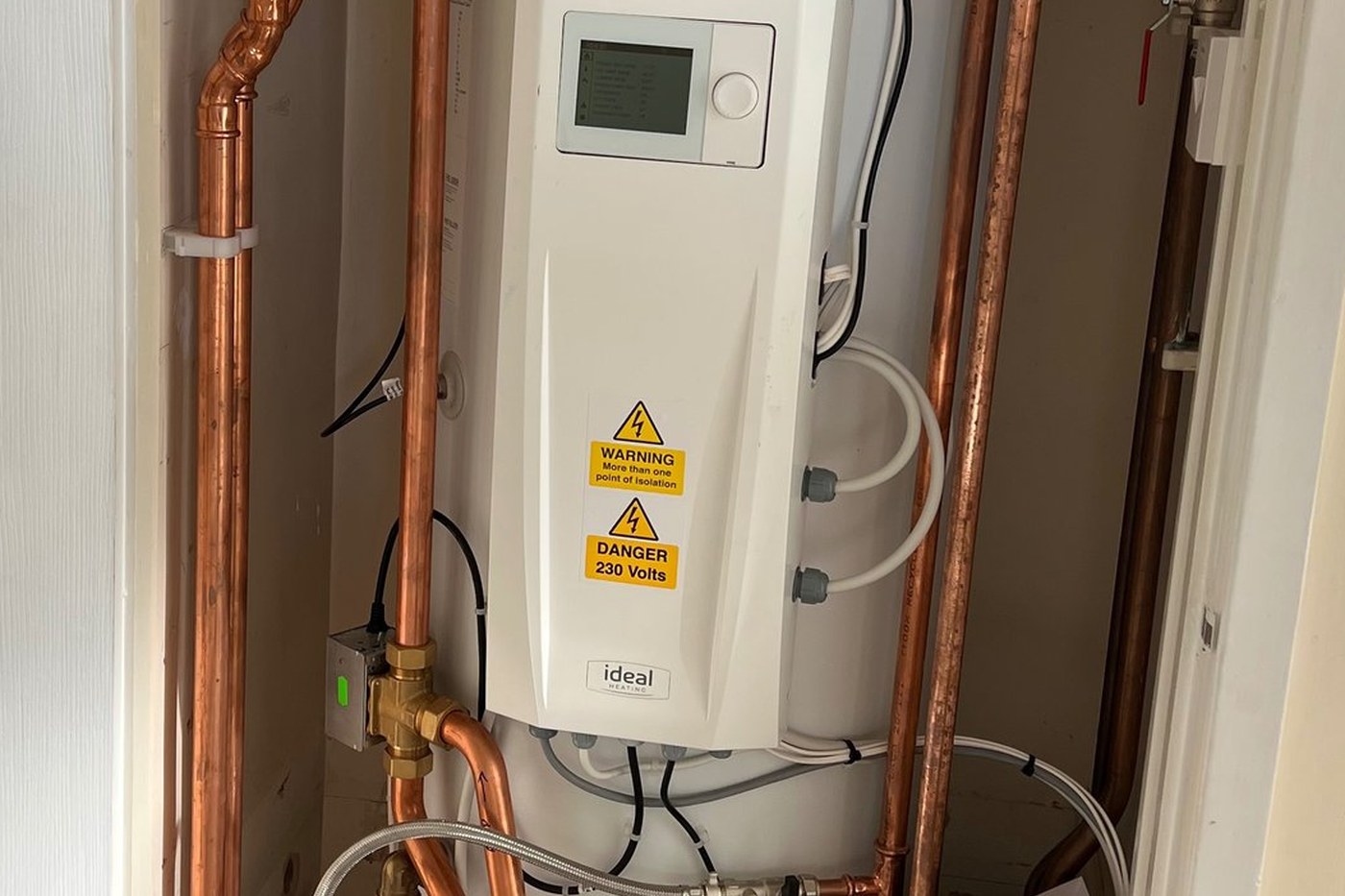 Plant and pipework on a service visit: cylinder, controller, brass isolation valves and copper flow and return